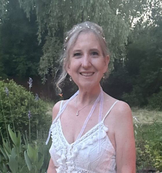 Smiling woman in white dress in garden