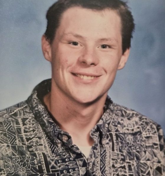 Smiling young man in patterned button-up shirt