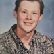 Smiling young man in patterned button-up shirt