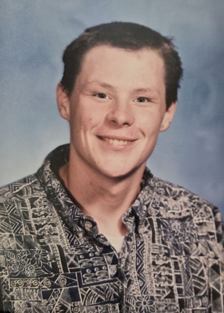 Smiling young man in patterned button-up shirt
