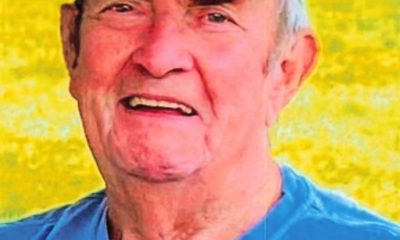 Elderly man in blue cap smiling outdoors