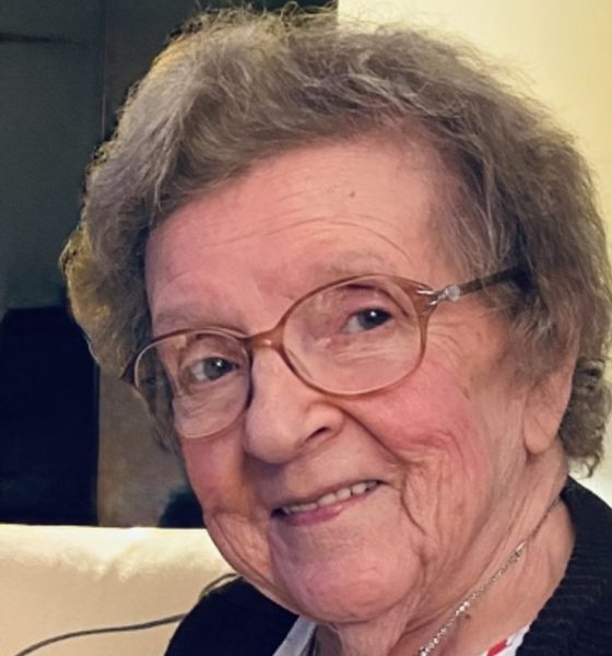 Smiling elderly woman wearing glasses indoors