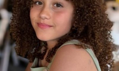 Smiling girl with curly hair indoors
