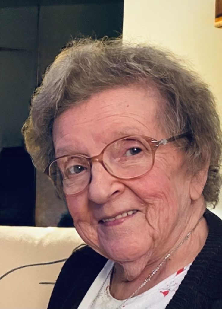 Smiling elderly woman wearing glasses indoors