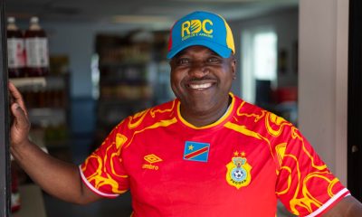 Smiling man in red Congo soccer jersey