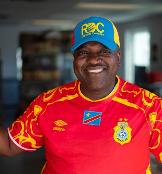 Smiling man in red Congo soccer jersey