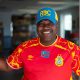 Smiling man in red Congo soccer jersey
