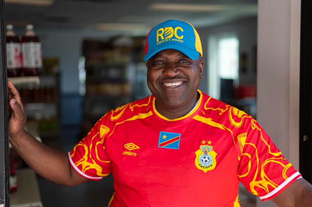 Smiling man in red Congo soccer jersey
