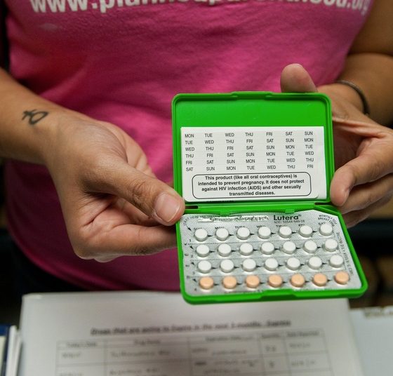 Person holding open birth control pill pack