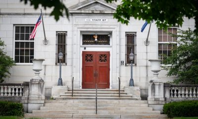 Entrance of 111 State Street building with flags