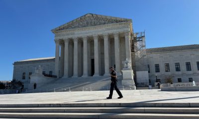 U.S. Supreme Court building with police officer outside