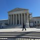 U.S. Supreme Court building with police officer outside