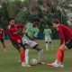 Soccer players battling for ball on field