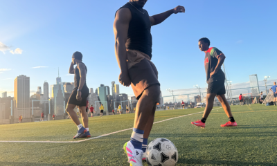 Man controlling soccer ball on city field