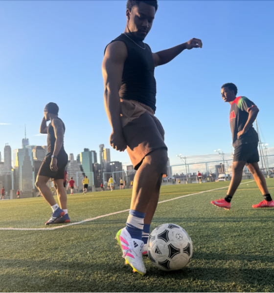 Man controlling soccer ball on city field