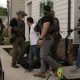 Officers detain man outside suburban home
