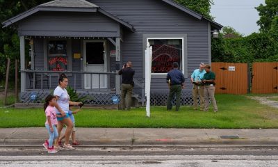 Police outside psychic reading house as family walks by