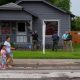 Police outside psychic reading house as family walks by