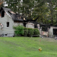 Fire-damaged house cordoned off with caution tape