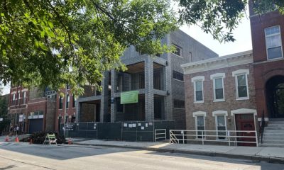 Modern brick building under construction on city street