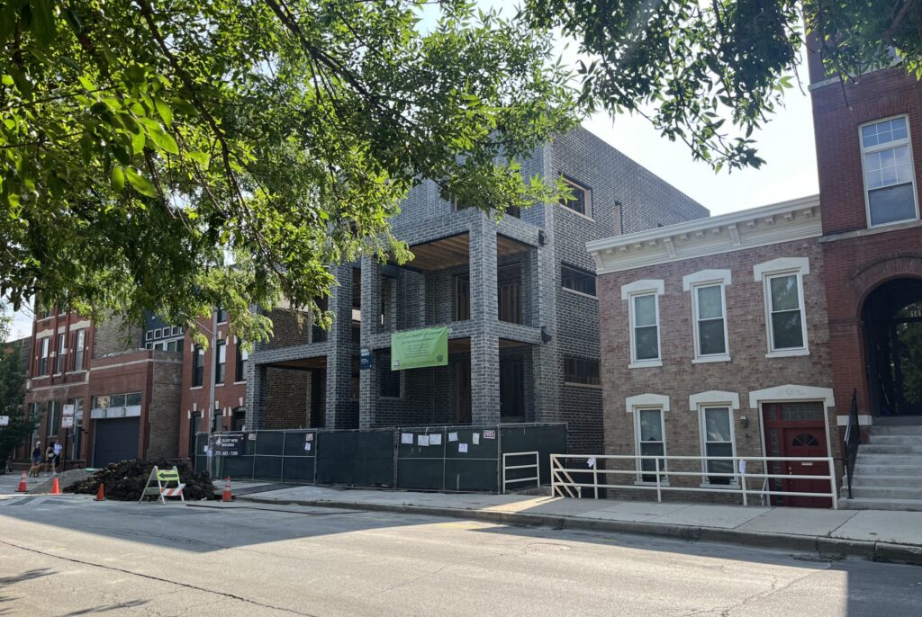 Modern brick building under construction on city street