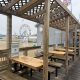 Covered boardwalk seating overlooking beach and Ferris wheel