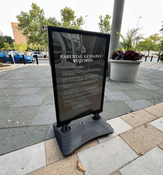 Parental guidance required sign on sidewalk