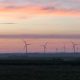 Wind turbines at sunset over rural landscape
