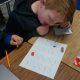 Children playing educational board game at classroom desk