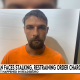 Man in orange shirt in police mugshot