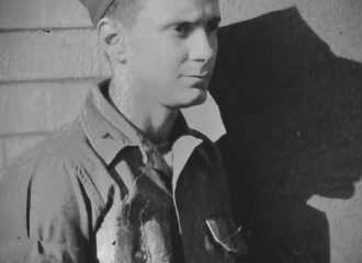 Black-and-white portrait of young soldier in uniform