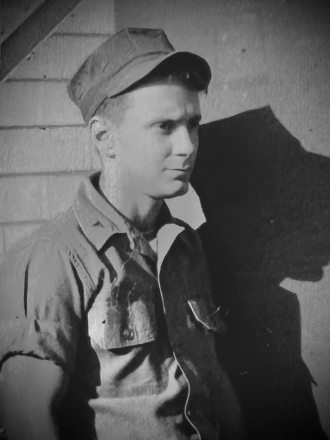 Black-and-white portrait of young soldier in uniform