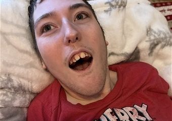 Person lying on pillow wearing red cartoon shirt