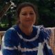 Woman sitting outdoors on wooden deck