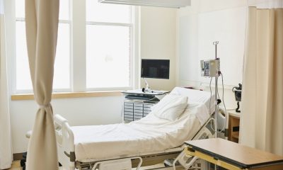 Empty hospital room with bed and equipment