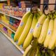 Bananas hanging in grocery store produce aisle