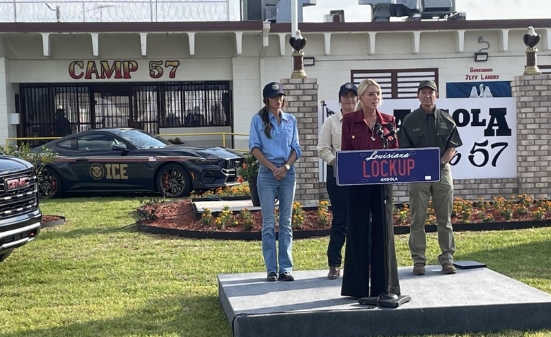 Press conference outside Camp 57 with ICE vehicle