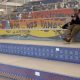 Man sitting on colorful mosaic bleachers indoors