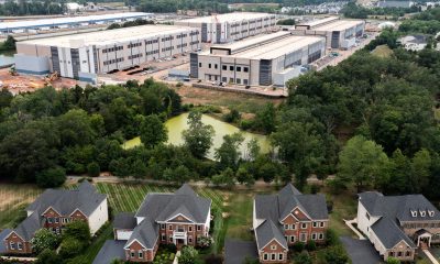 Industrial warehouse complex behind suburban neighborhood