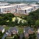 Industrial warehouse complex behind suburban neighborhood