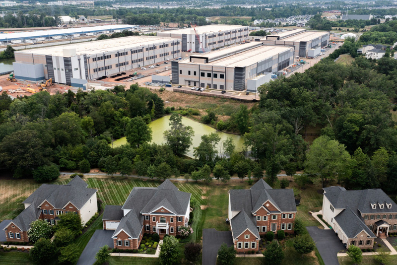 Industrial warehouse complex behind suburban neighborhood