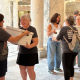 Women carrying document boxes inside marble government building