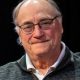 Elderly man wearing glasses and zip-up sweater