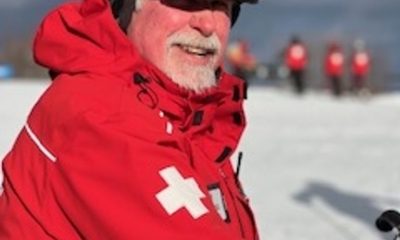 Ski patrol member in red jacket on snow