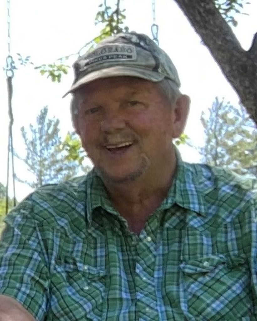 Smiling older man in green plaid shirt outdoors