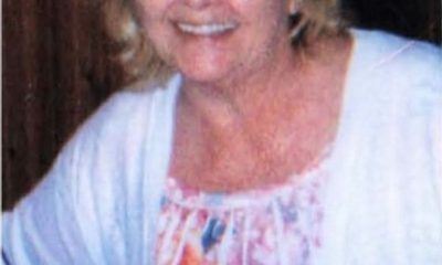 Smiling woman with glasses in floral blouse