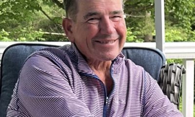 Smiling older man sitting on outdoor porch chair