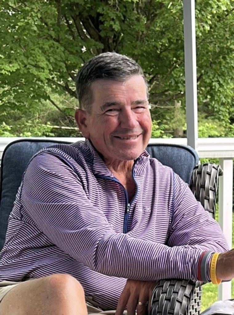 Smiling older man sitting on outdoor porch chair