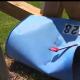 Damaged blue mailbox lying on the ground