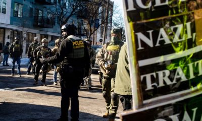 Border Patrol officers standing on city street